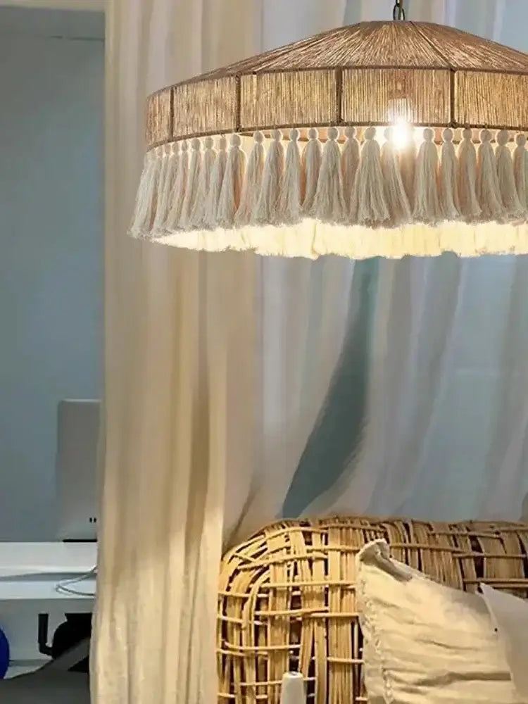Wooden pendant light with fringe hanging above a sofa in a room Besontique Home