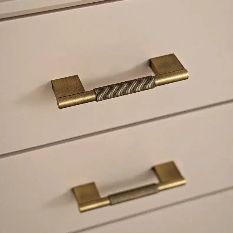 Set of bronze cabinet handles on a textured surface Besontique Home Decor 