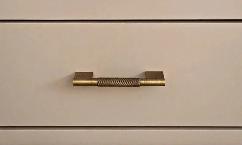 Set of bronze cabinet handles on a textured surface Besontique Home Decor 