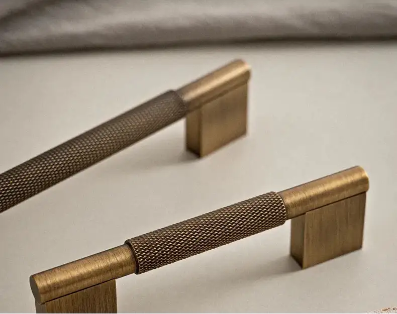 Set of bronze cabinet handles on a textured surface Besontique Home Decor 