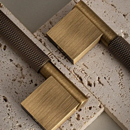 Set of bronze cabinet handles on a textured surface Besontique Home Decor 