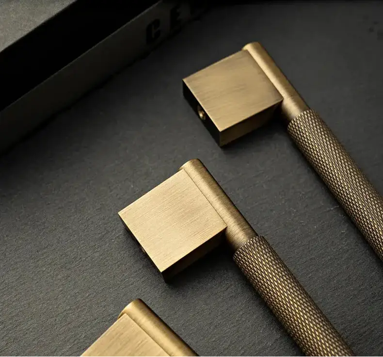 Gold door handles on a dark surface